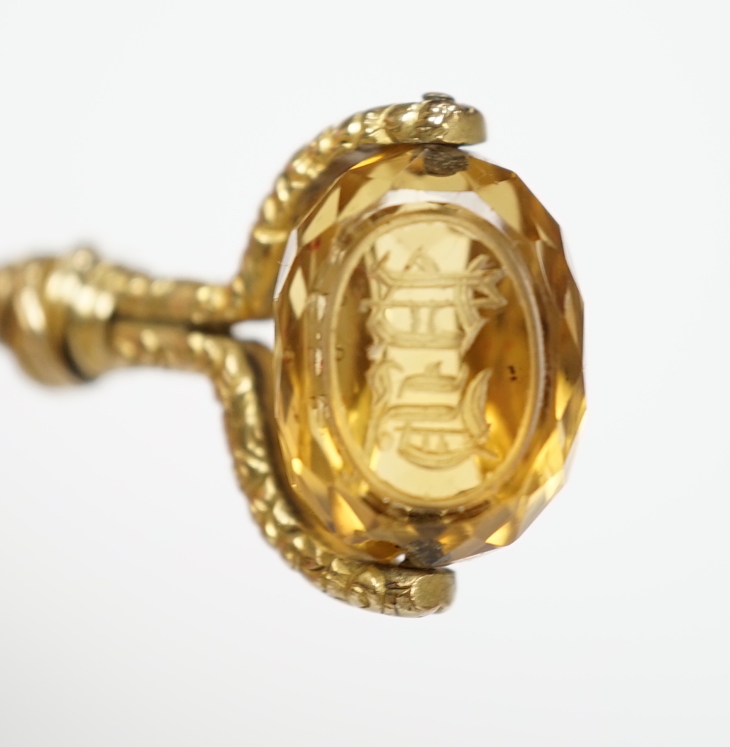 A Victorian yellow metal overlaid and swivelling citrine set watch key, 49mm.